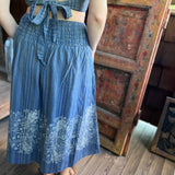 Someone wearing the blue Midnight Floral Midi Skirt.