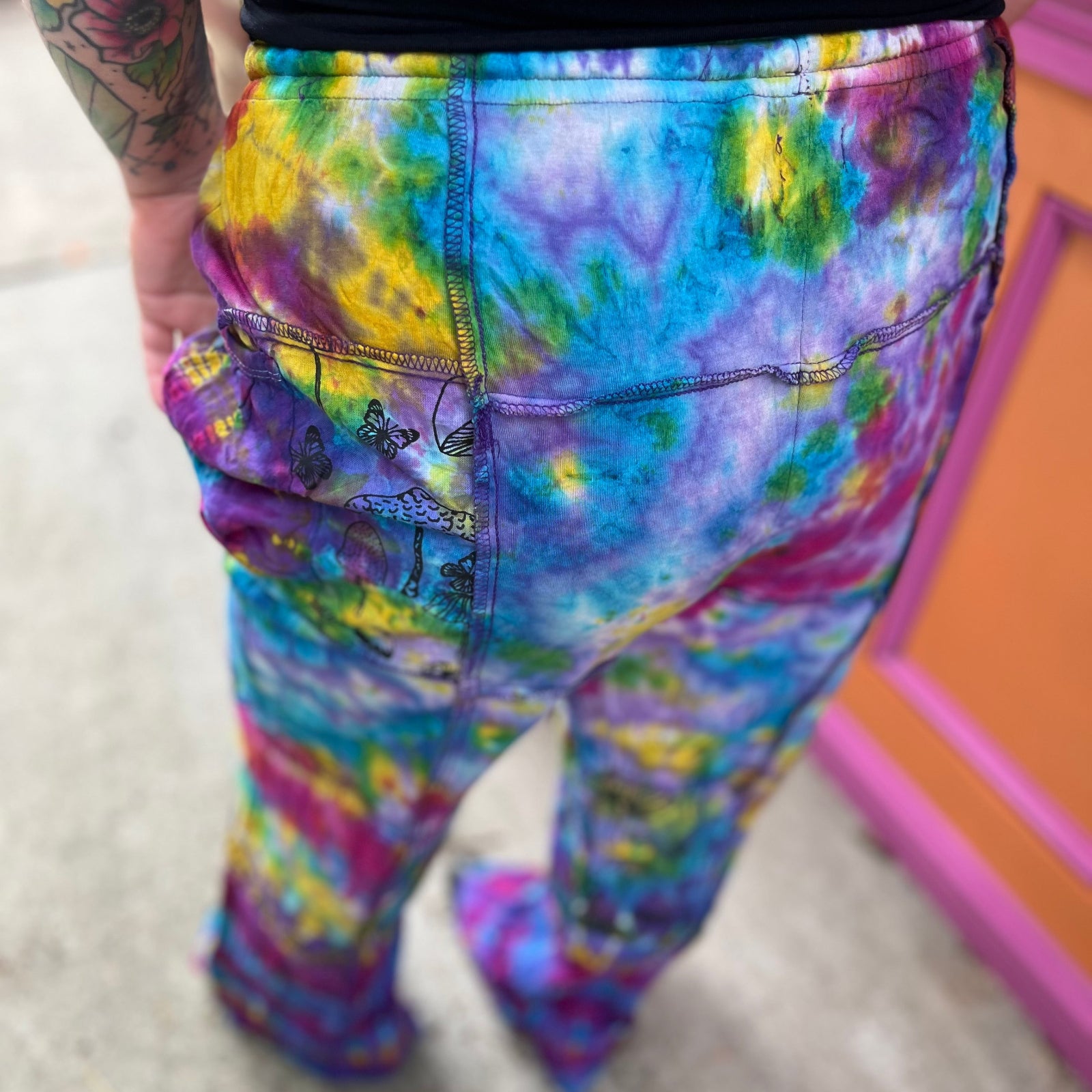 A woman wearing the Rainbow Tie Dye Pocket Bell Cotton Trouser.