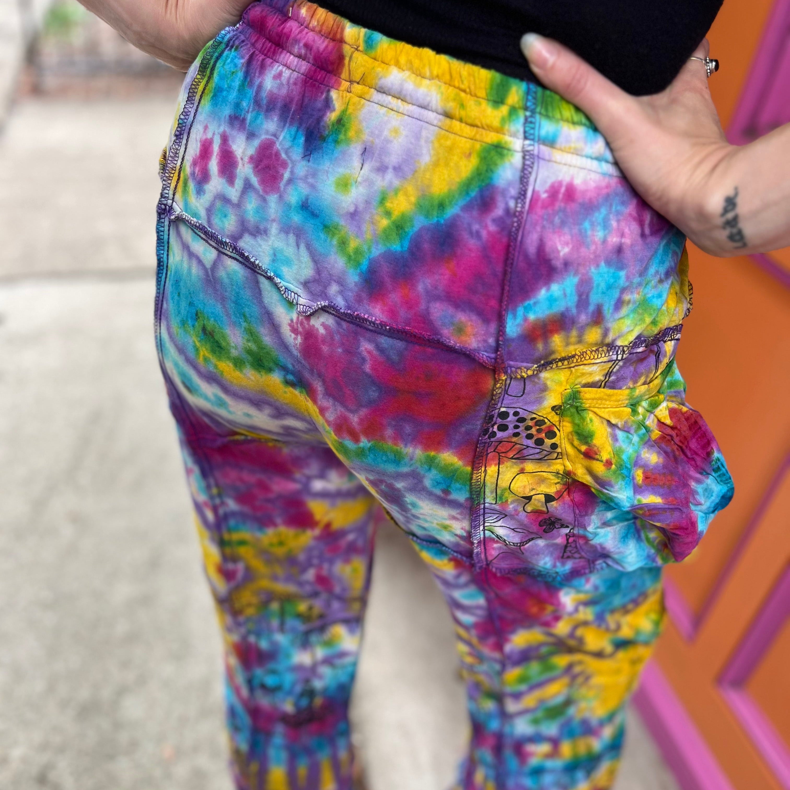 A woman wearing the Rainbow Tie Dye Pocket Bell Cotton Trouser, showing off the back.