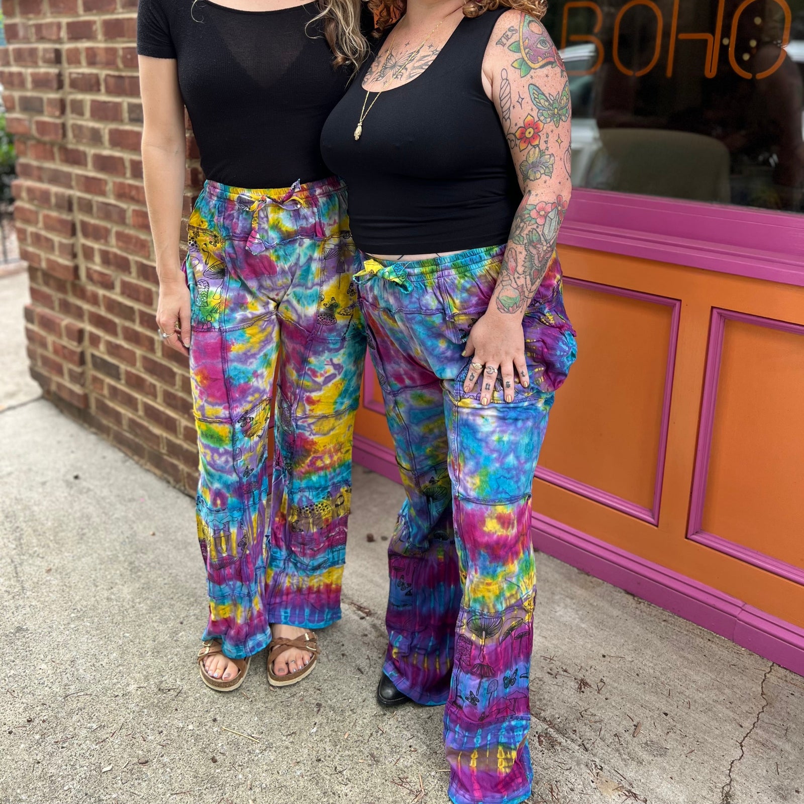 Two women wearing the Rainbow Tie Dye Pocket Bell Cotton Trouser.