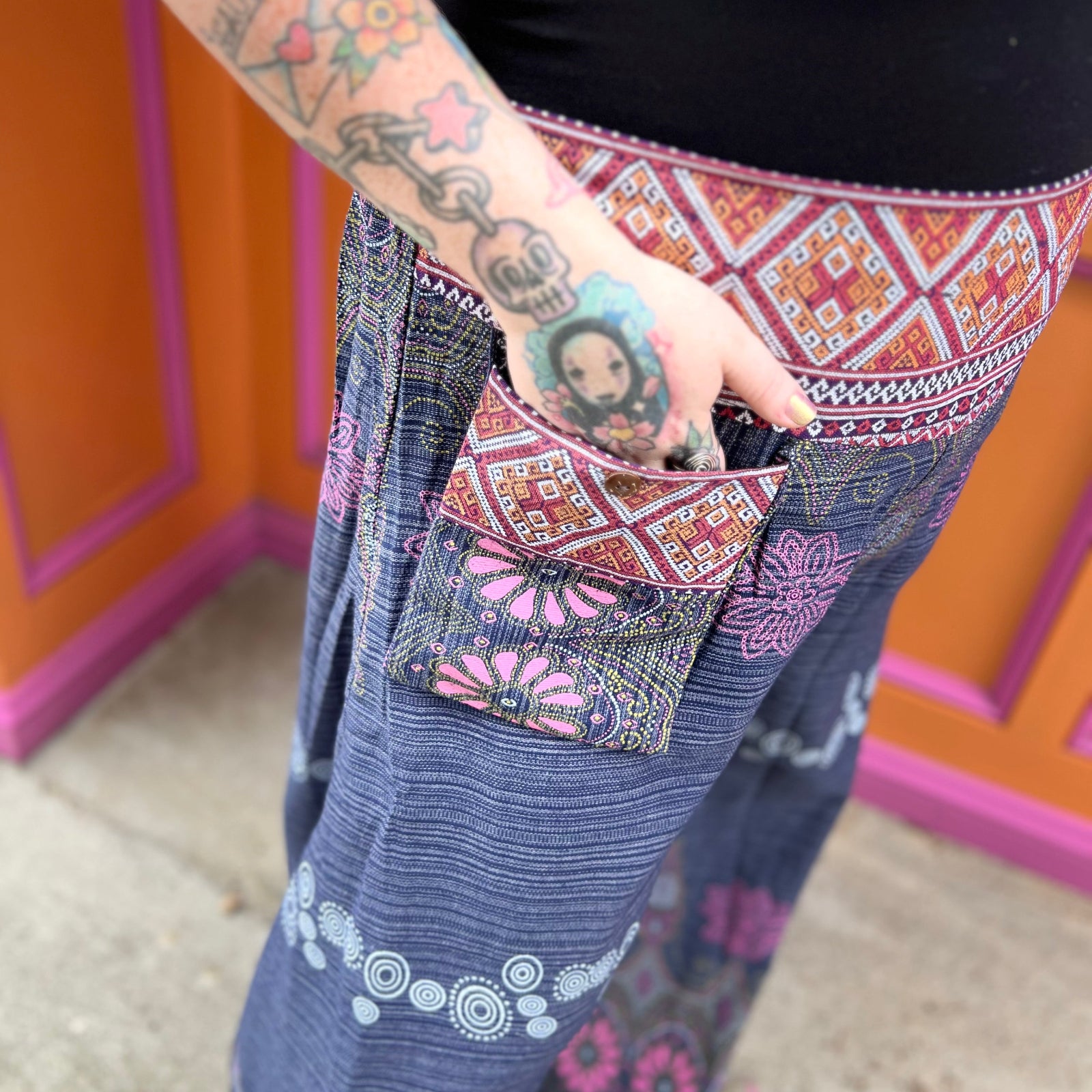 A woman wearing the Purple Floral Cotton Trousers.