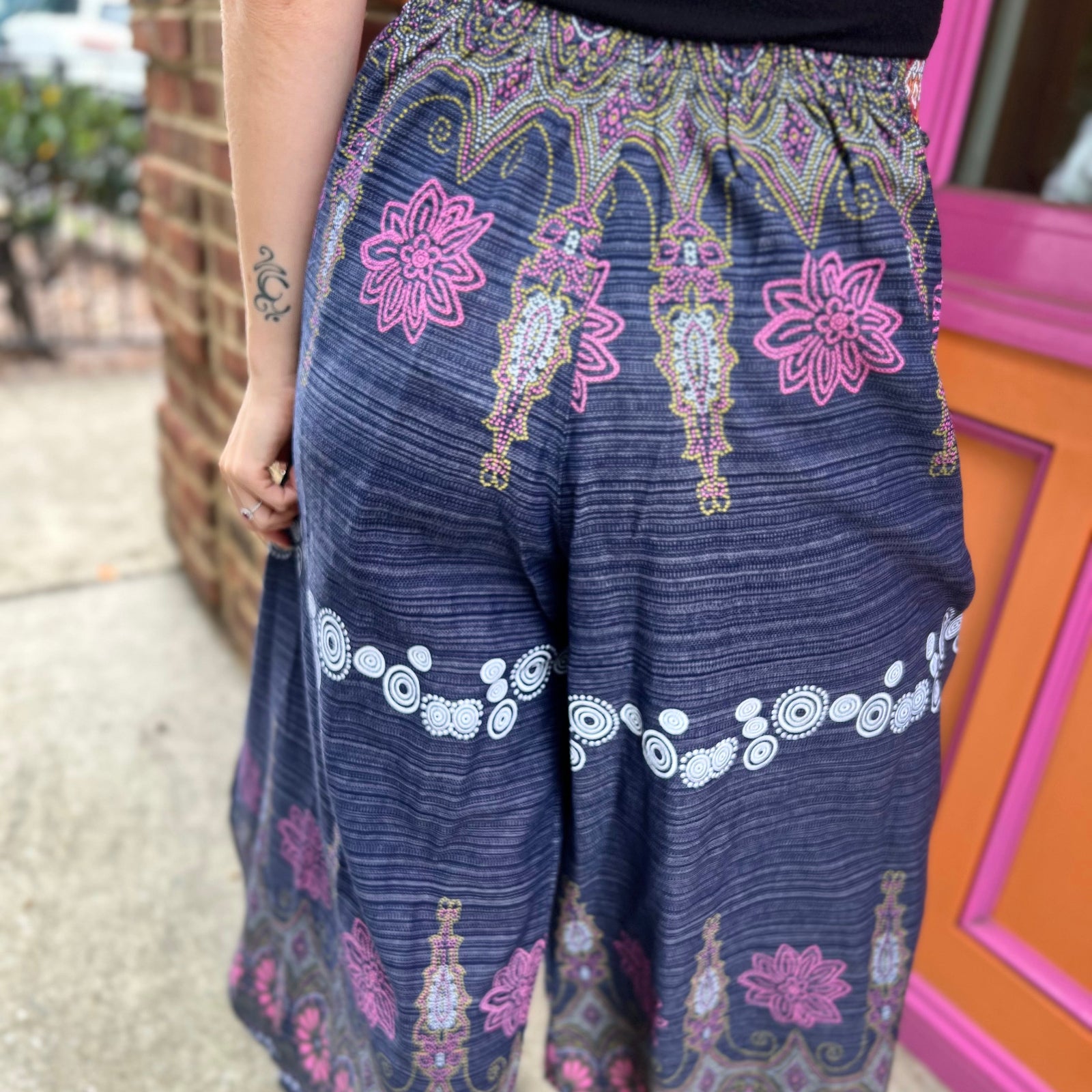 A woman wearing the Purple Floral Cotton Trousers.