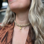 Someone wearing the cream Macrame Pendant Choker Necklace.