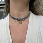 Someone wearing the blue gray Macrame Pendant Choker Necklace.