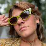 Someone wearing the Frenchie Seventies Cat-Eye Sunglasses with an orange patterned kimono.