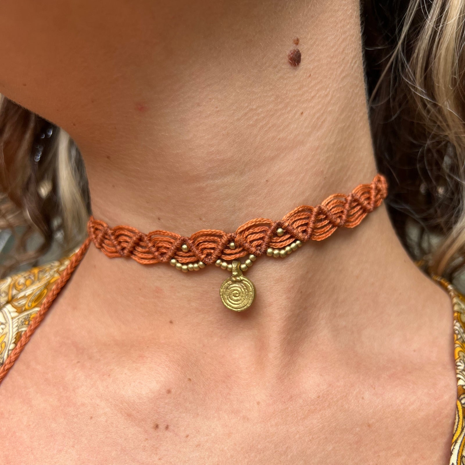 Someone wearing the rust Macrame Pendant Choker Necklace.