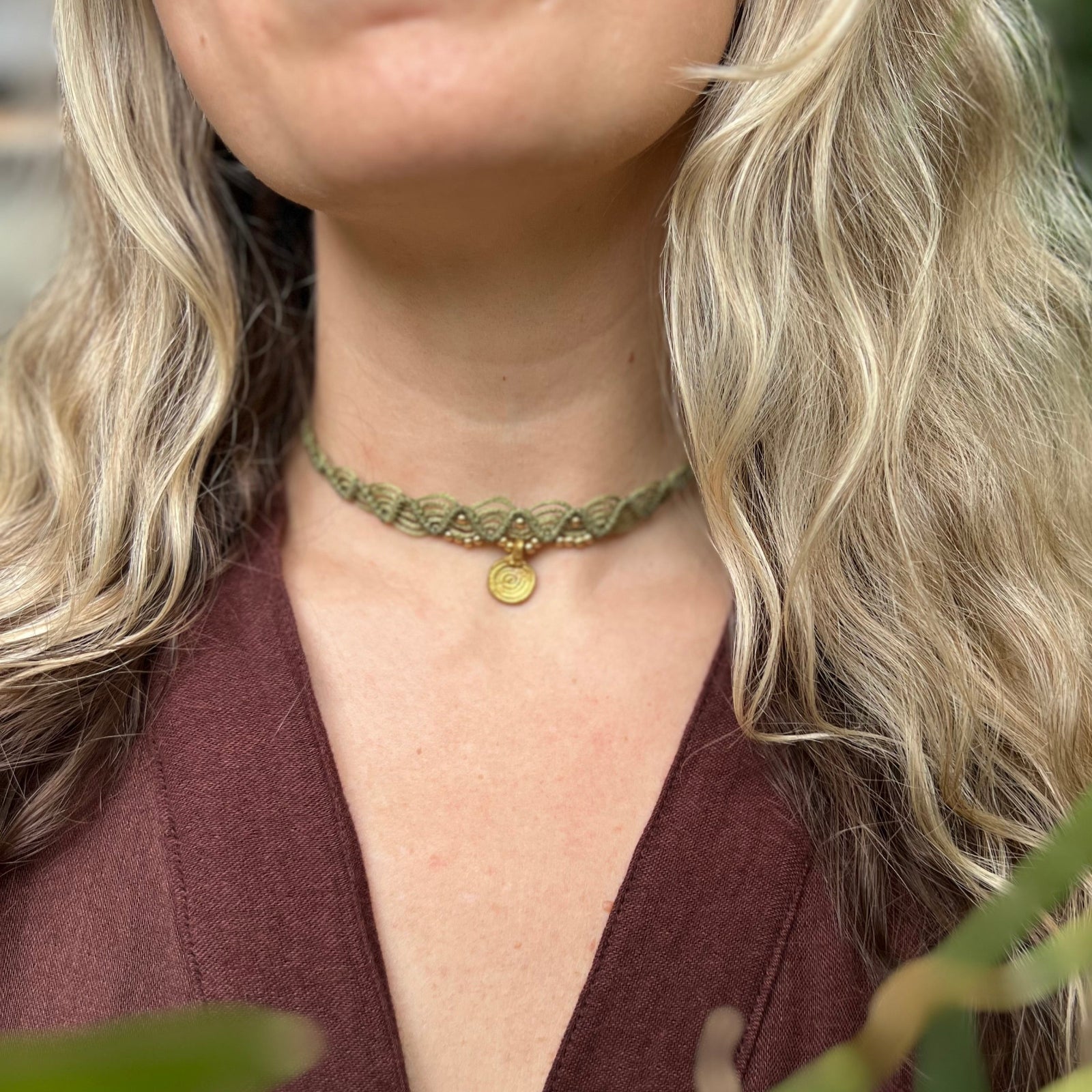Someone wearing the green Macrame Pendant Choker Necklace.