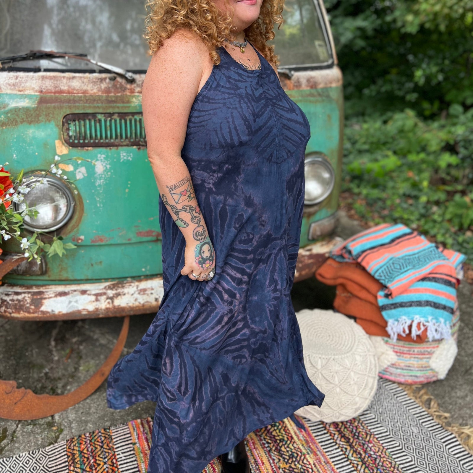 A woman wearing the spellbound Hippie Boho Maxi Flowy Tie Dye Dress in front of a vintage Volkswagen Bus.
