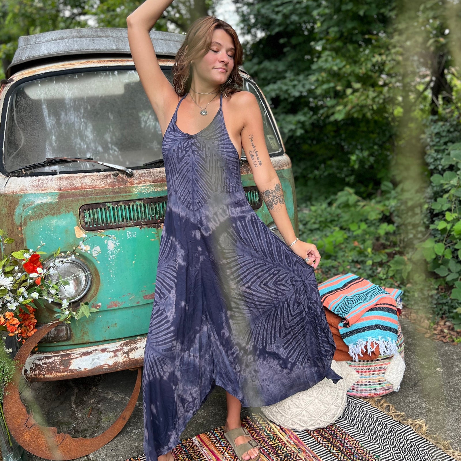 A woman wearing the spellbound Hippie Boho Maxi Flowy Tie Dye Dress in front of a vintage Volkswagen Bus.