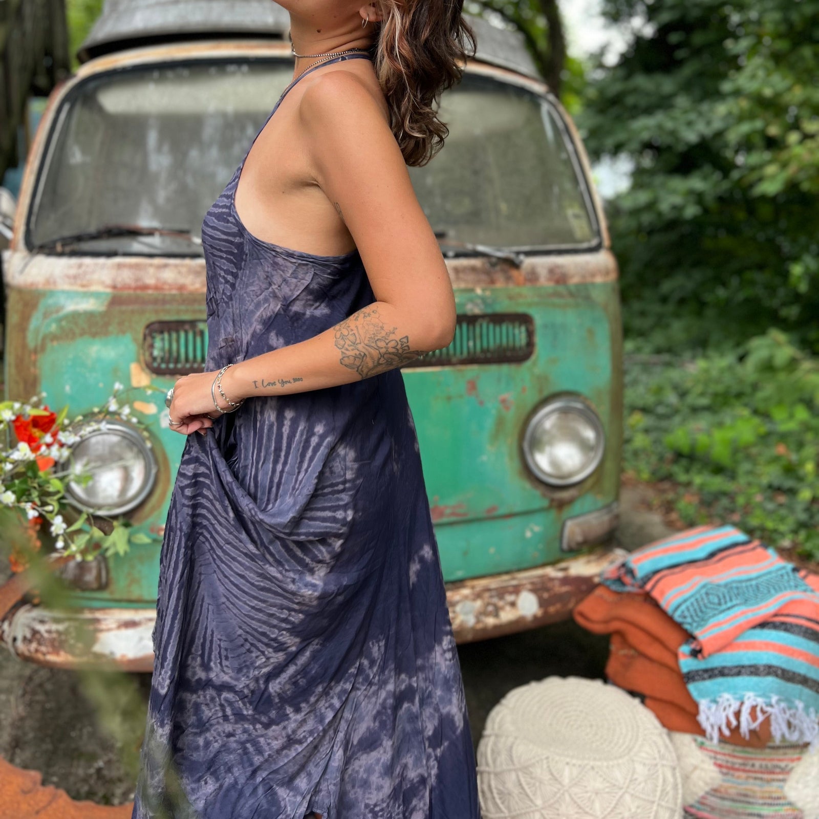 A woman wearing the spellbound Hippie Boho Maxi Flowy Tie Dye Dress in front of a vintage Volkswagen Bus.