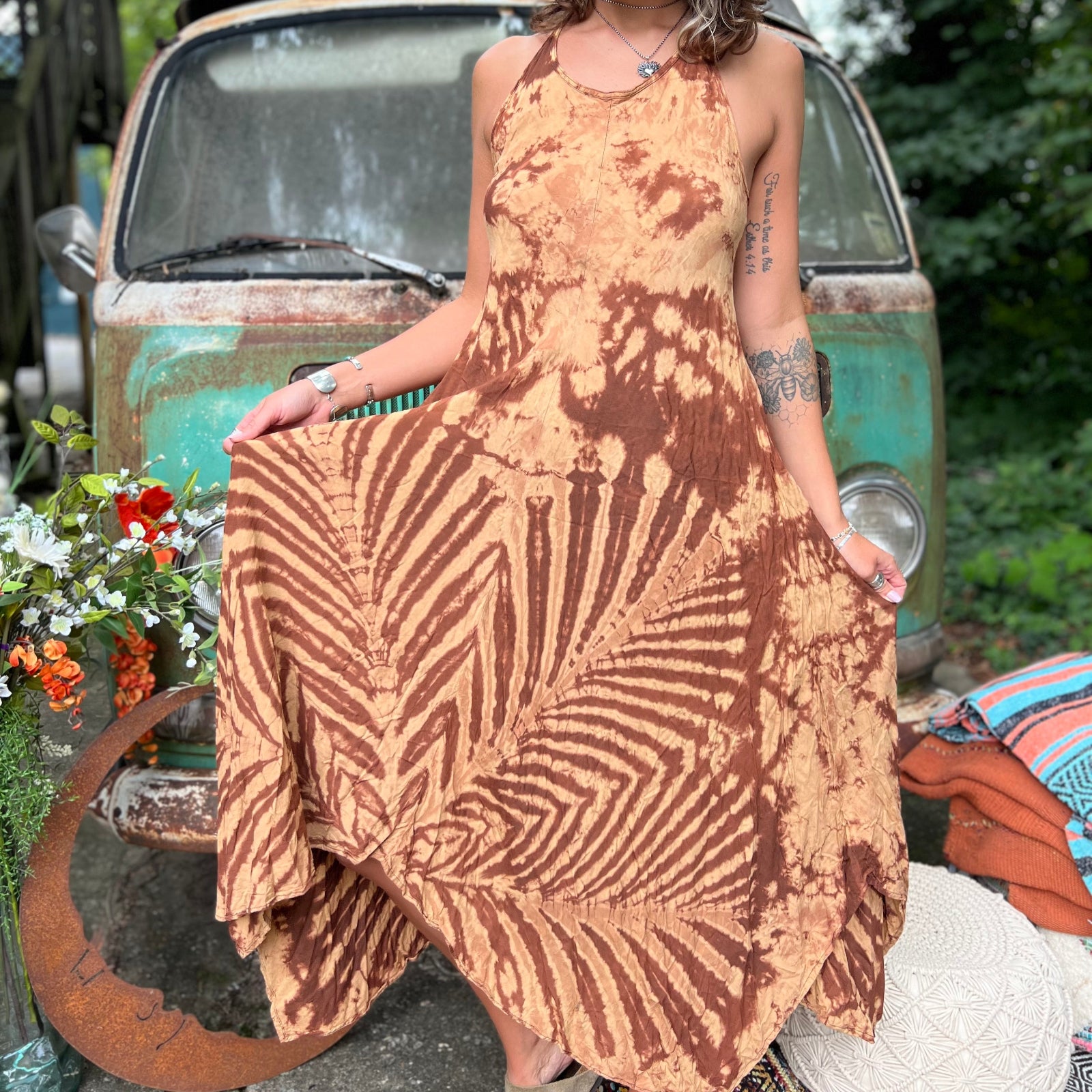 A woman wearing the amber gold Hippie Boho Maxi Flowy Tie Dye Dress in front of a vintage Volkswagen Bus.