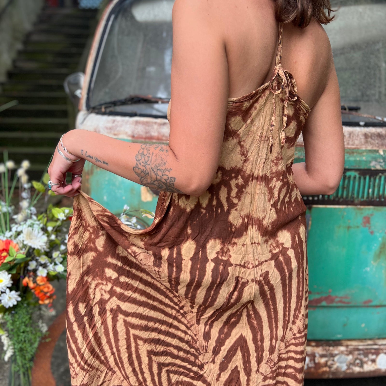 A woman wearing the amber gold Hippie Boho Maxi Flowy Tie Dye Dress in front of a vintage Volkswagen Bus.