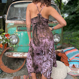 A woman wearing the moondance mauve gold Hippie Boho Maxi Flowy Tie Dye Dress in front of a vintage Volkswagen Bus.