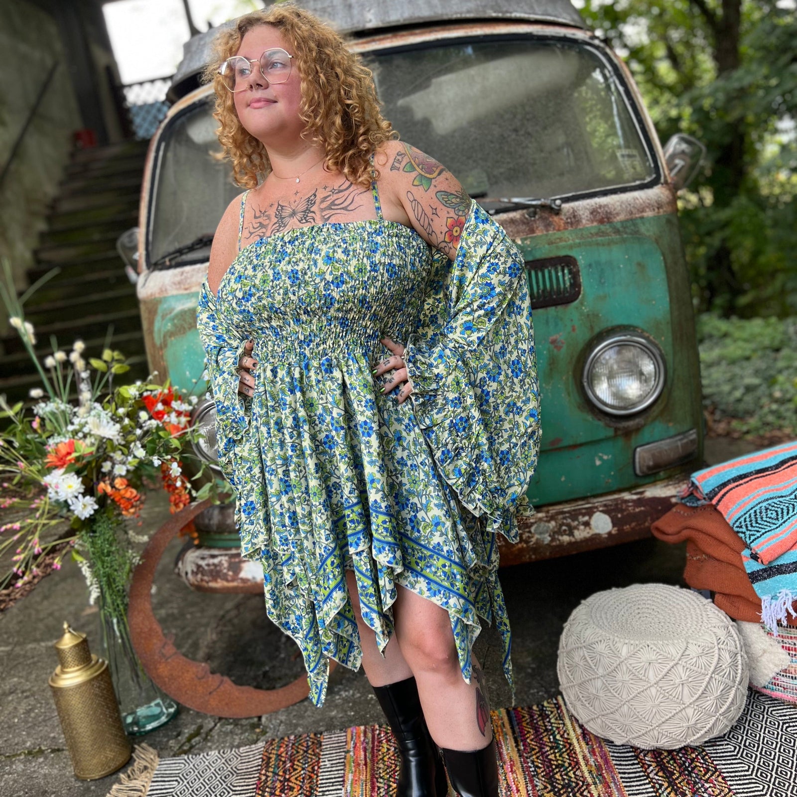 A woman wearing the green Hippie Bohemian Fairy Dress with Elastic Fairy Skirt in front of a vintage Volkswagen bus.