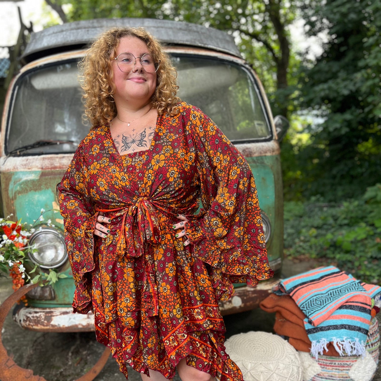 A woman wearing the red Hippie Bohemian Fairy Dress with Elastic Fairy Skirt in front of a vintage Volkswagen bus.