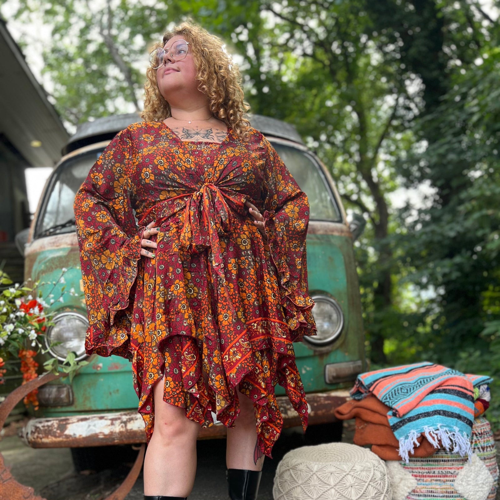 A woman wearing the red Hippie Bohemian Fairy Dress with Elastic Fairy Skirt in front of a vintage Volkswagen bus.