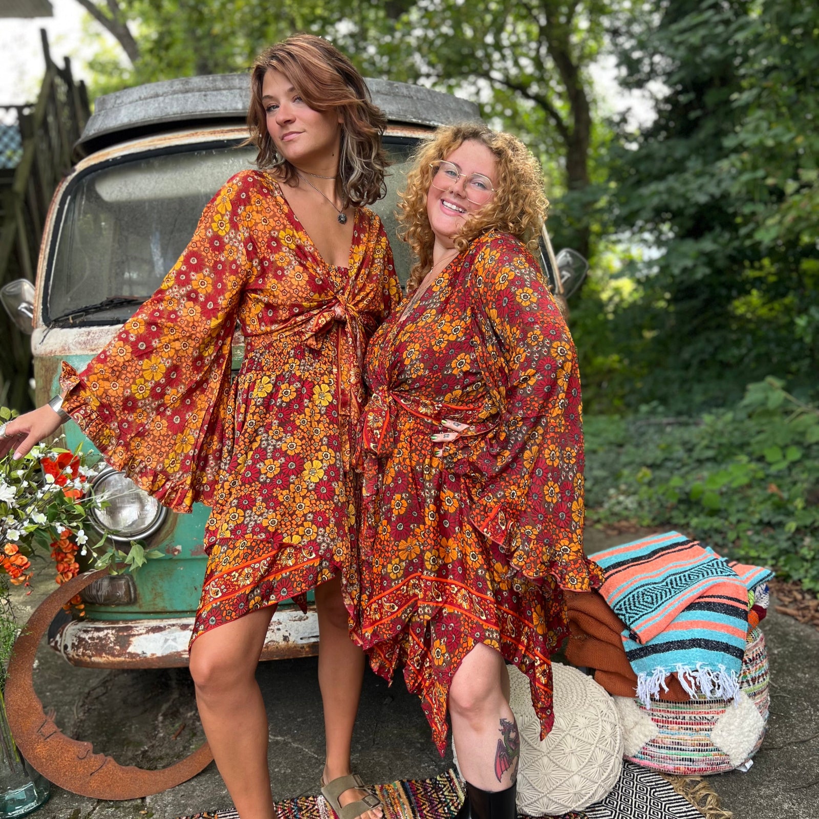 Two women wearing the red Hippie Bohemian Fairy Dress with Elastic Fairy Skirt in front of a vintage Volkswagen bus.