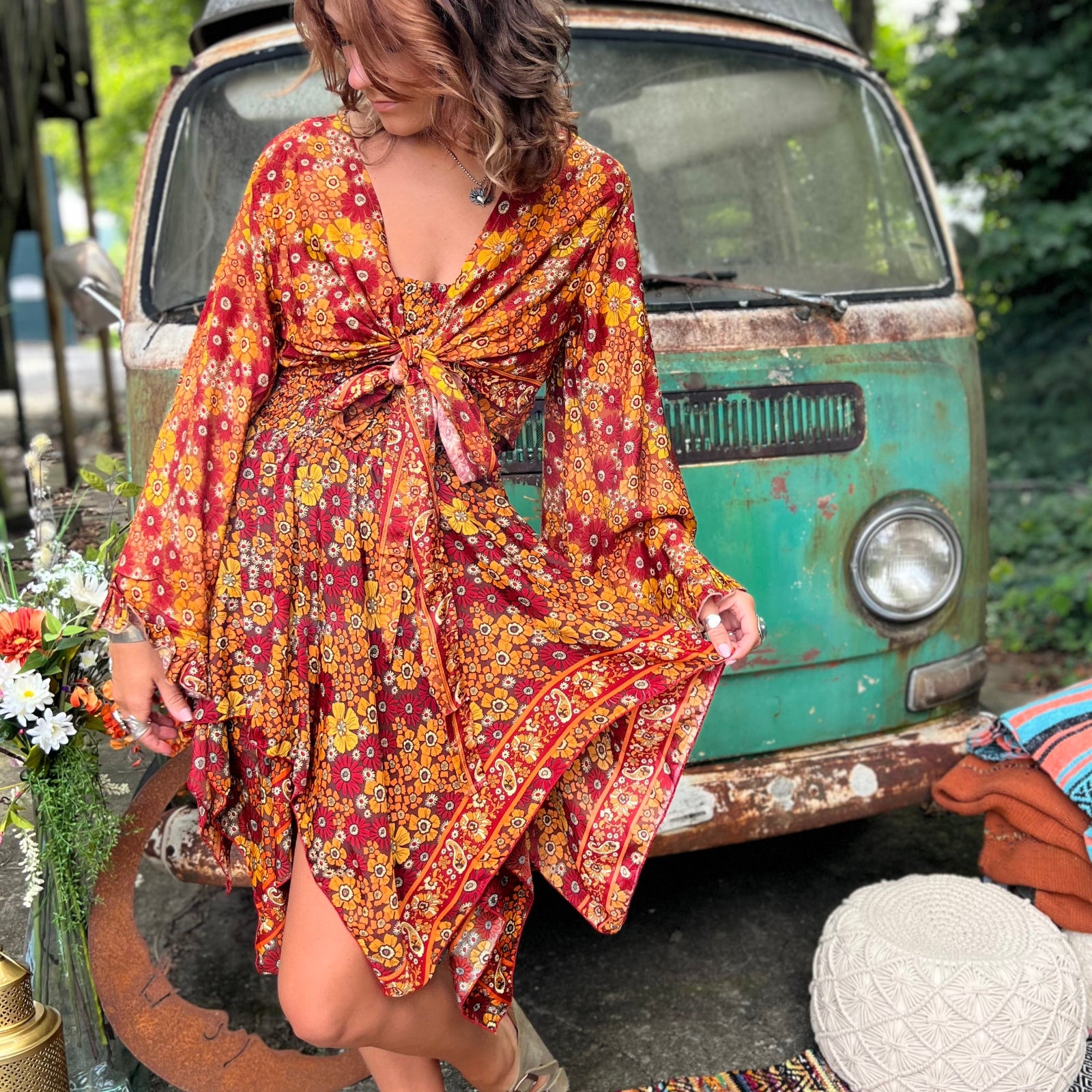 A woman wearing the red Hippie Bohemian Fairy Dress with Elastic Fairy Skirt in front of a vintage Volkswagen bus.