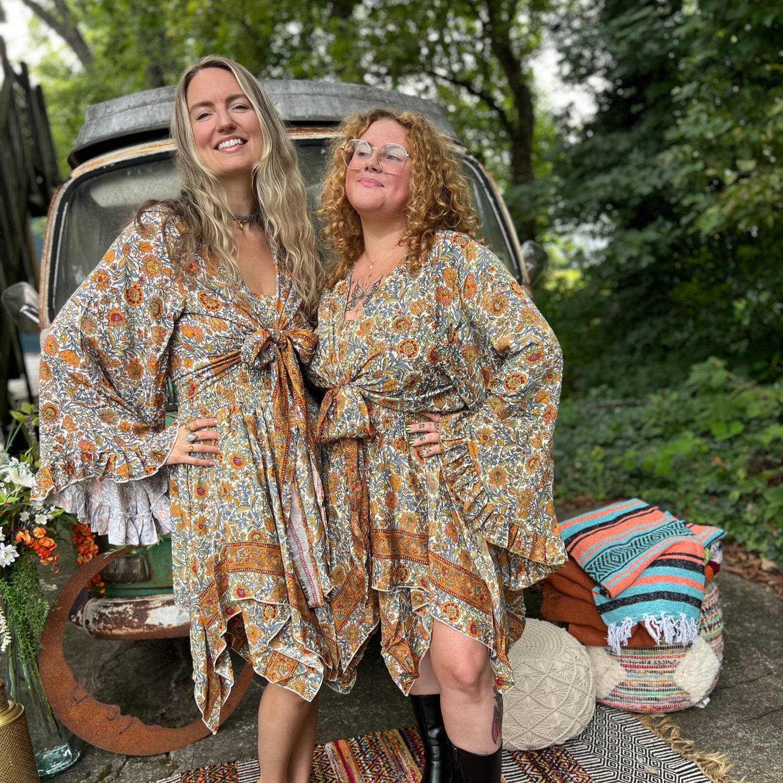 Two women wearing the orange and cream Hippie Bohemian Fairy Dress with Elastic Fairy Skirt in front of a vintage Volkswagen bus.