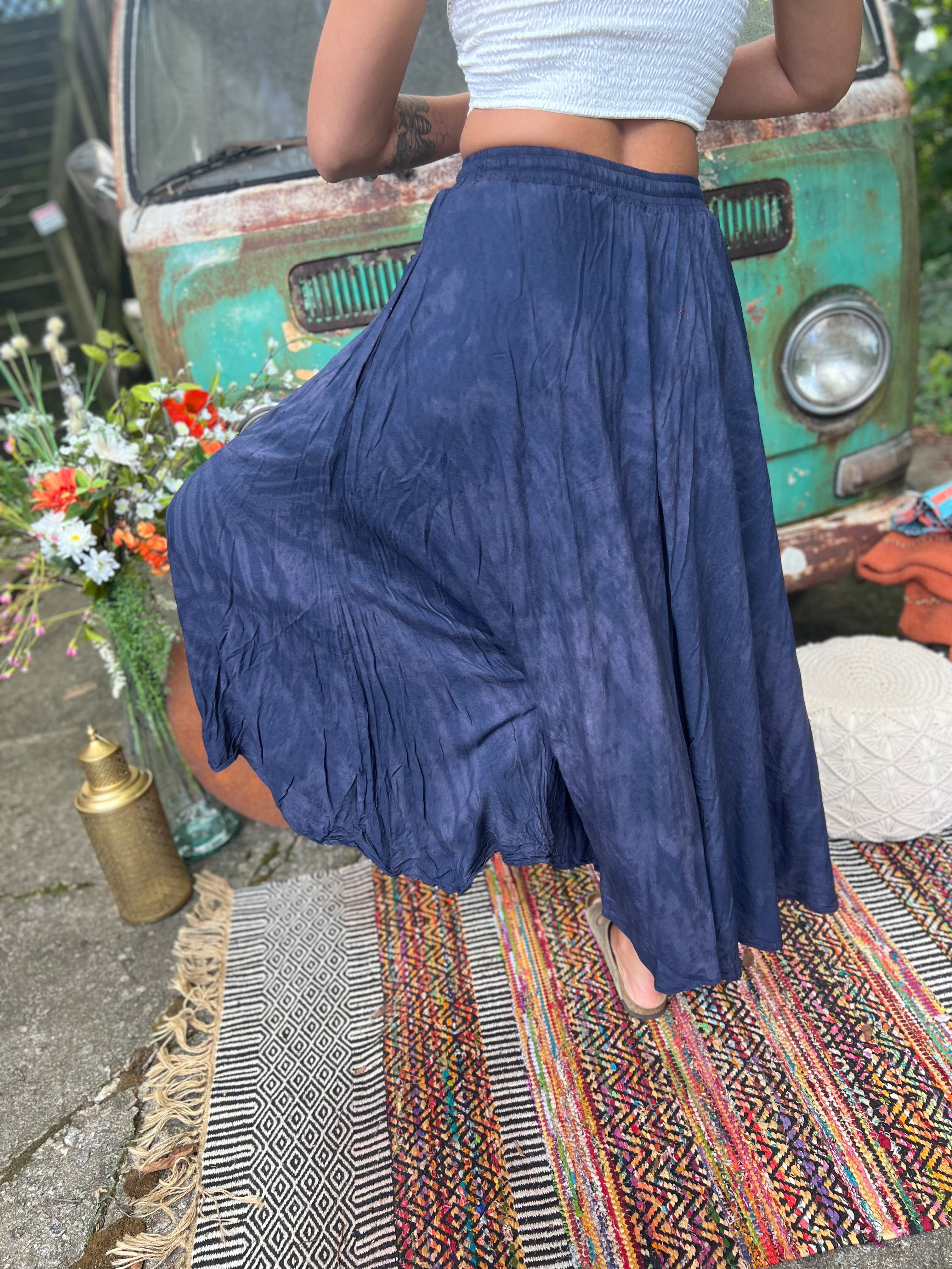 A woman wearing the navy Hippie Bohemian Hand Dyed Palazzo Pants in front of a vintage Volkswagen bus.