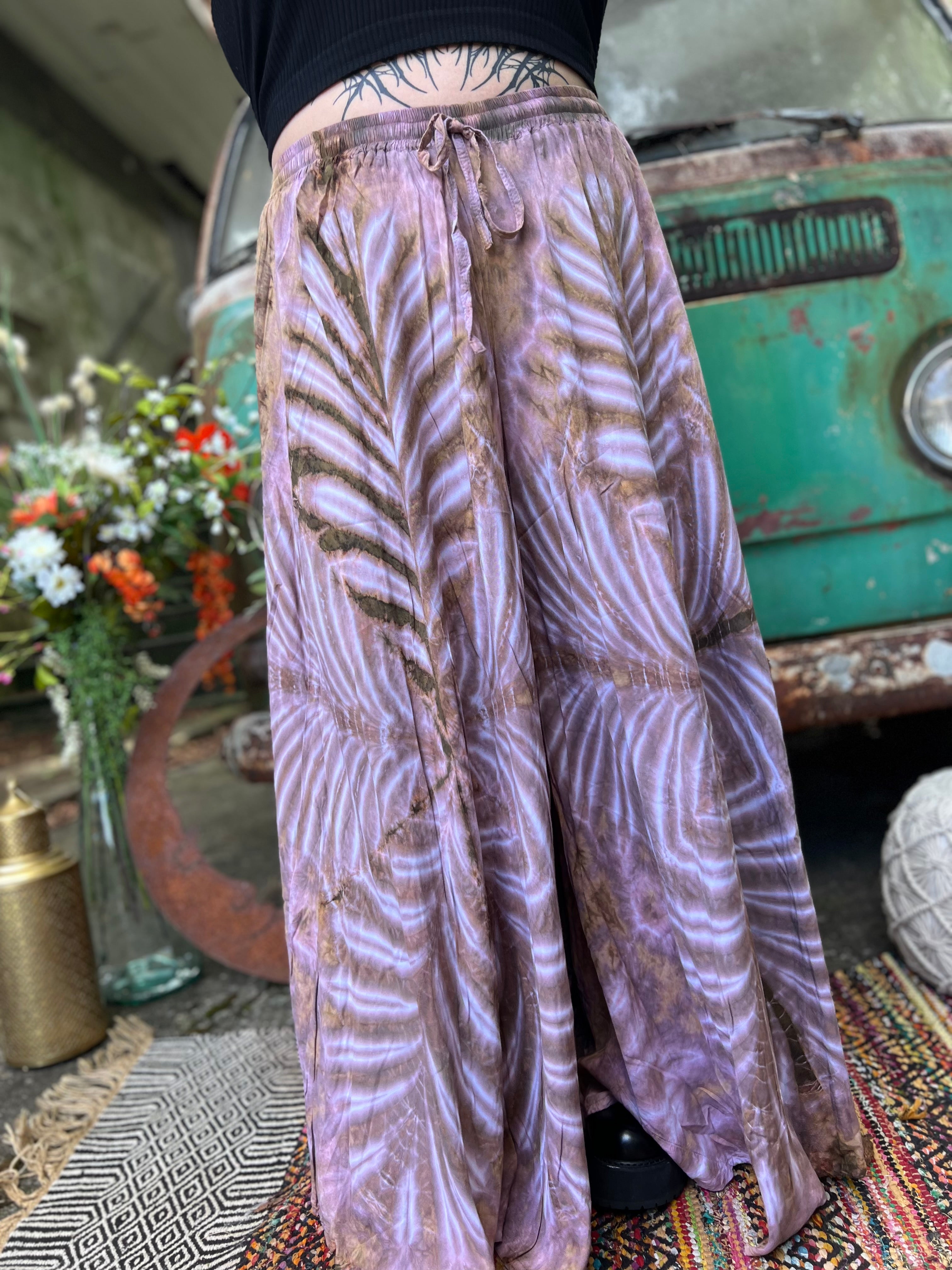A woman wearing the mauve Hippie Bohemian Hand Dyed Palazzo Pants in front of a vintage Volkswagen bus.