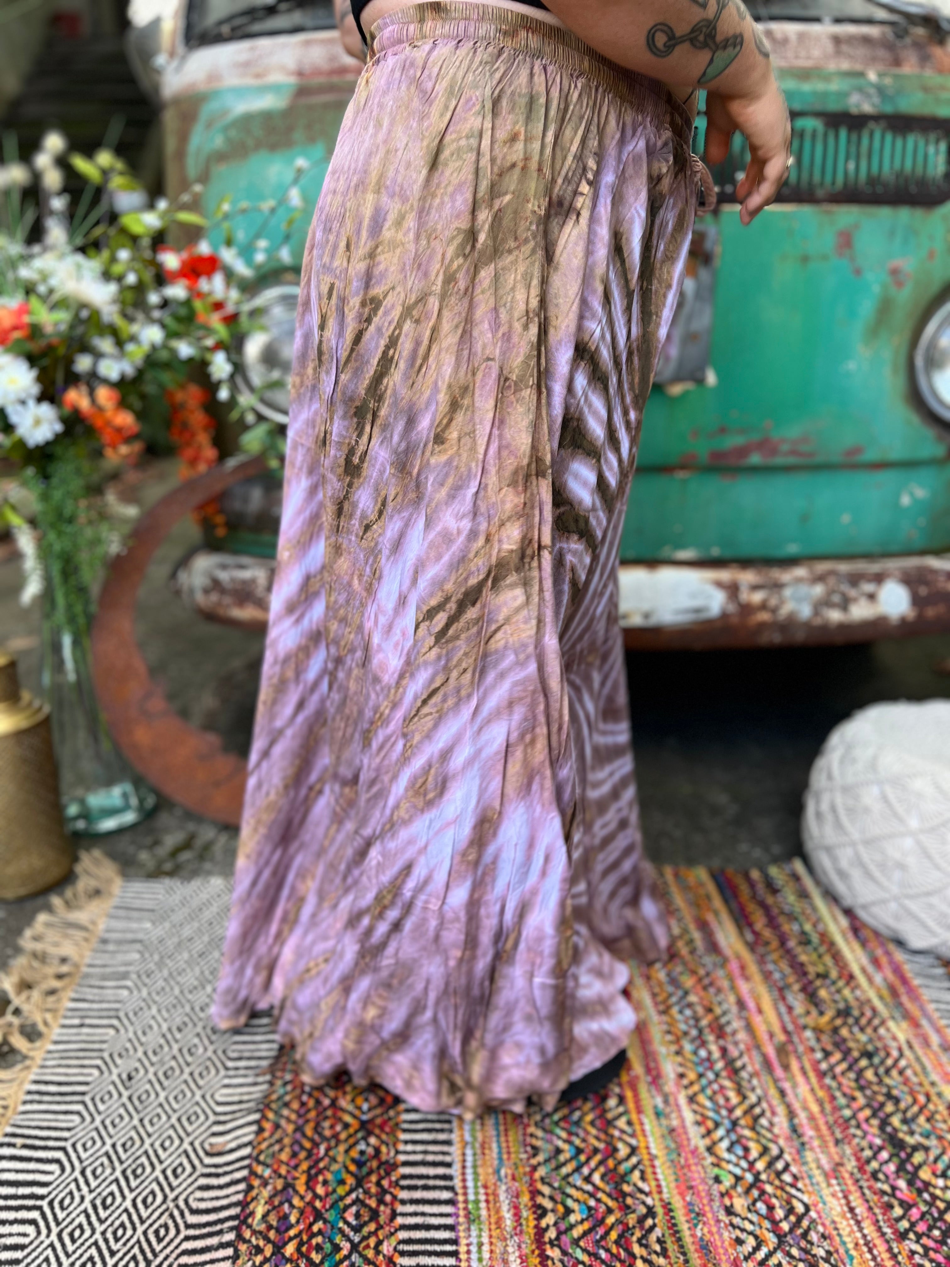 A woman wearing the mauve Hippie Bohemian Hand Dyed Palazzo Pants in front of a vintage Volkswagen bus.