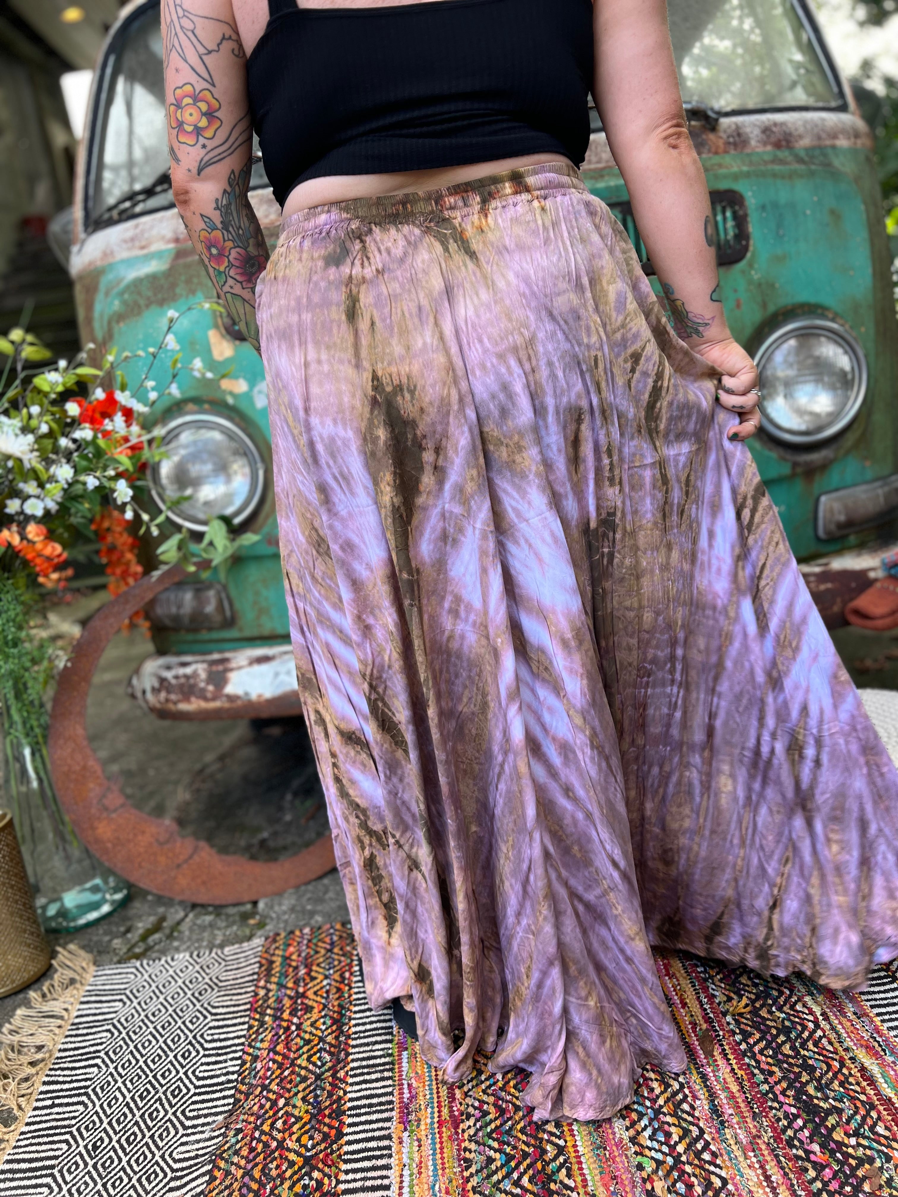 A woman wearing the mauve Hippie Bohemian Hand Dyed Palazzo Pants in front of a vintage Volkswagen bus.