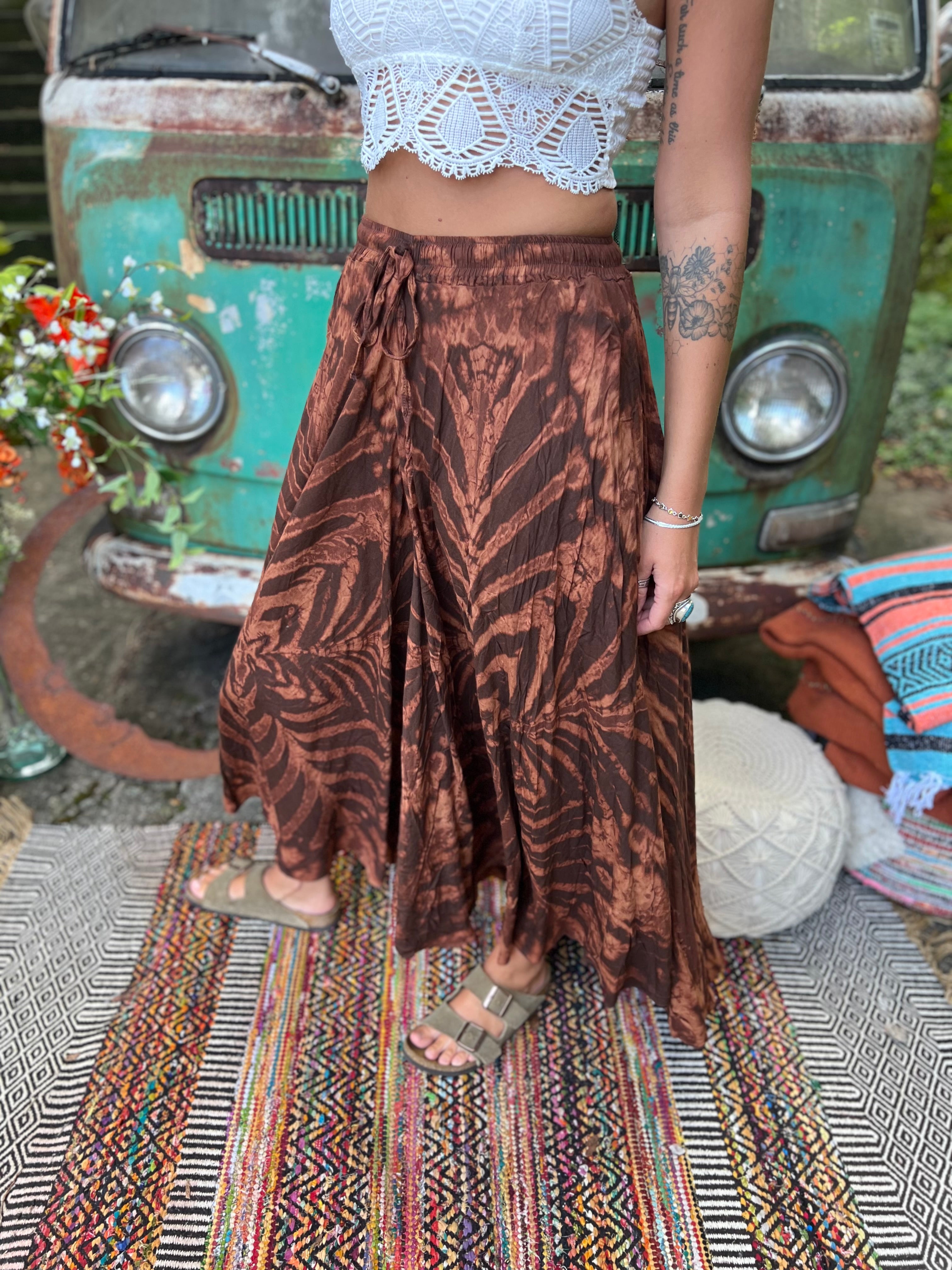 A woman wearing the brown Hippie Bohemian Hand Dyed Palazzo Pants in front of a vintage Volkswagen bus.