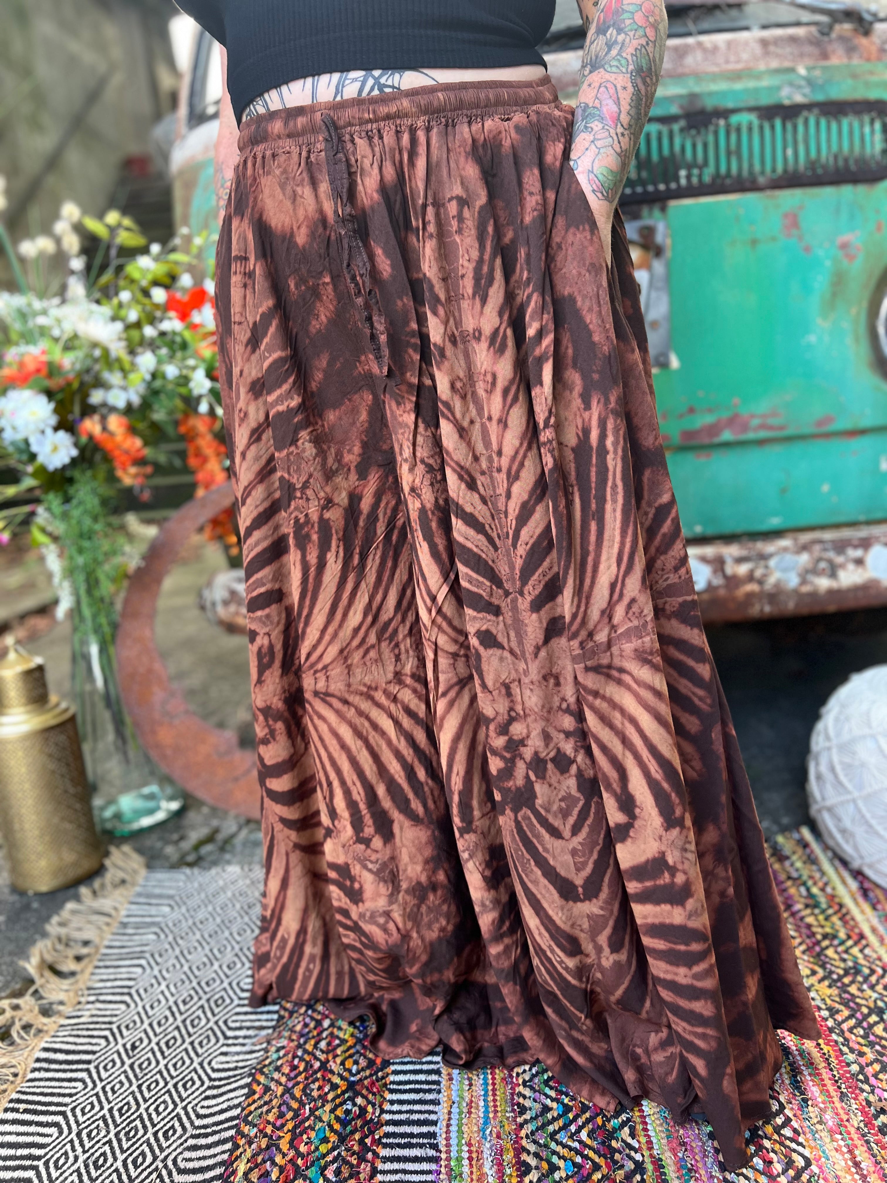 A woman wearing the brown Hippie Bohemian Hand Dyed Palazzo Pants in front of a vintage Volkswagen bus.