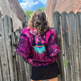 A woman wearing the Faux Fur Jacket in Monster Pink by Jennafer Grace with a black dress.