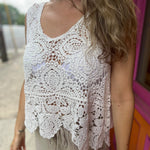 A woman wearing the Vintage Crochet Hollow-Out Tank Top with a beige linen pants.