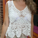 A woman wearing the Vintage Crochet Hollow-Out Tank Top with a beige linen pants.