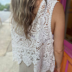 A woman wearing the Vintage Crochet Hollow-Out Tank Top with a beige linen pants.