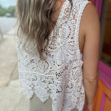 A woman wearing the Vintage Crochet Hollow-Out Tank Top with a beige linen pants.