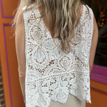 A woman wearing the Vintage Crochet Hollow-Out Tank Top with a beige linen pants.