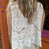 A woman wearing the Vintage Crochet Hollow-Out Tank Top with a beige linen pants.