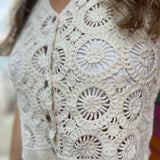A woman wearing the beige V-Neck Crochet Button Up Vest.