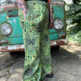 A woman wearing the Green Patch Cotton Palazzo Pants in front of a vintage Volkswagen bus.