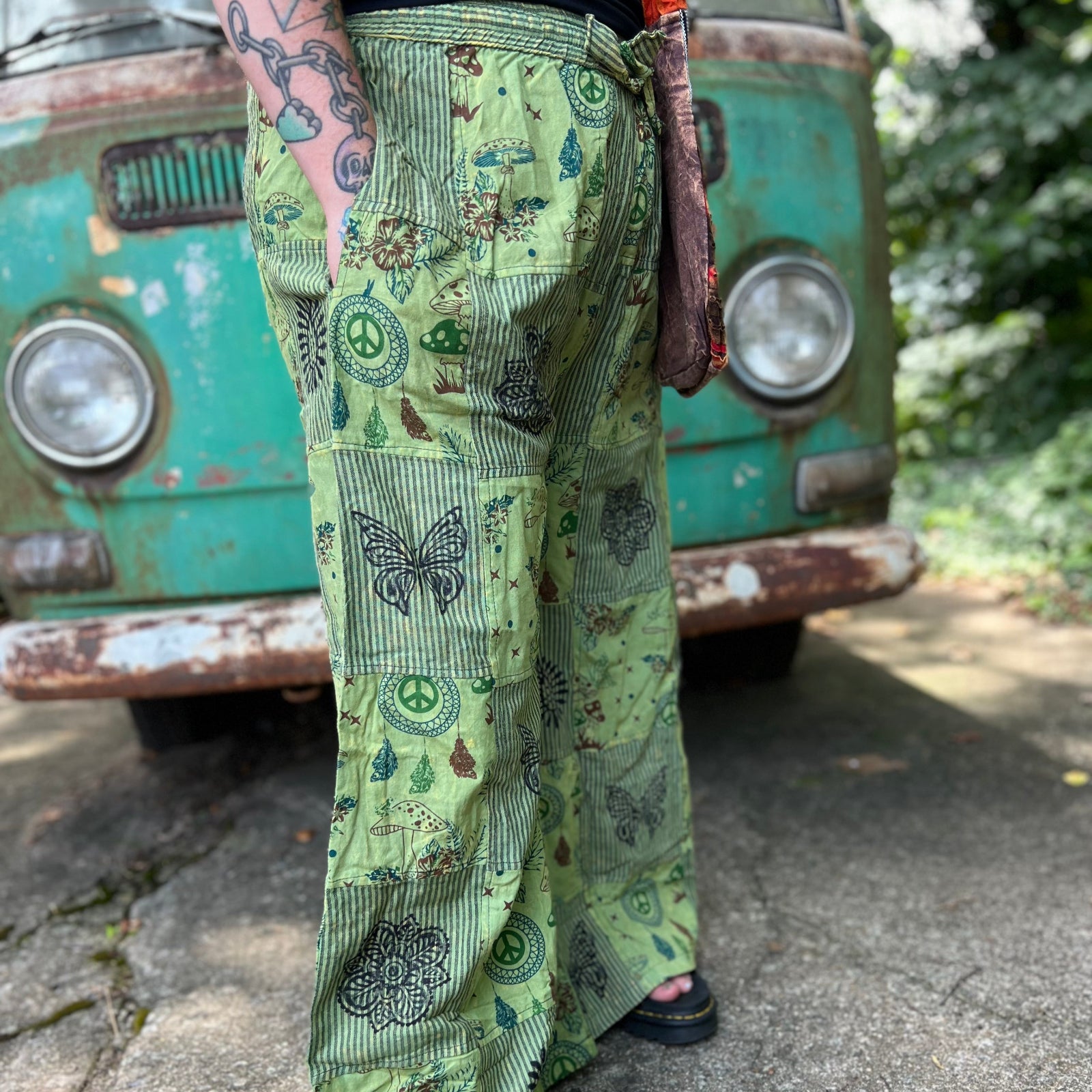 A woman wearing the Green Patch Cotton Palazzo Pants in front of a vintage Volkswagen bus.