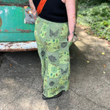 A woman wearing the Green Patch Cotton Palazzo Pants in front of a vintage Volkswagen bus.