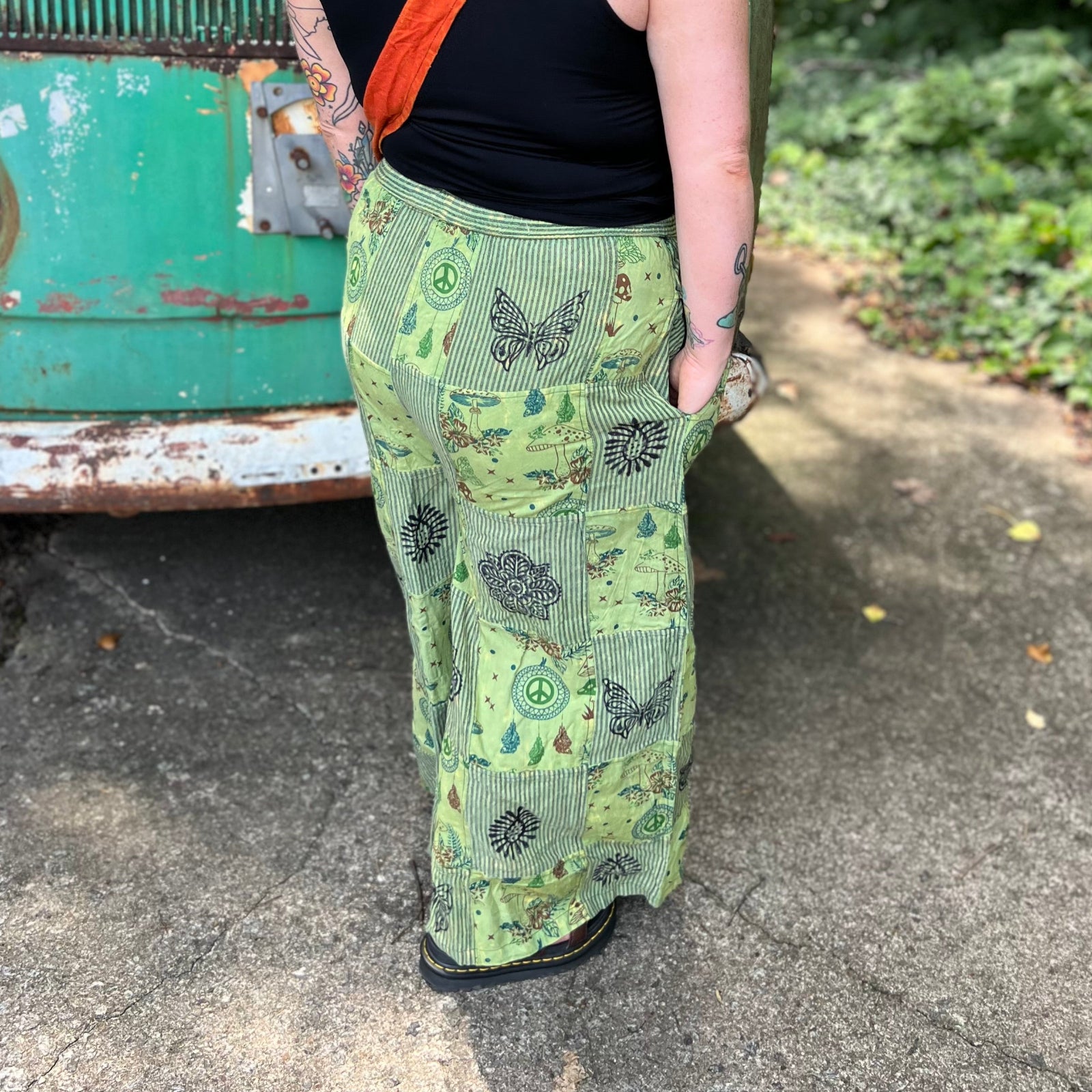A woman wearing the Green Patch Cotton Palazzo Pants in front of a vintage Volkswagen bus.