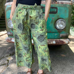 A woman wearing the Green Patch Cotton Palazzo Pants in front of a vintage Volkswagen bus.