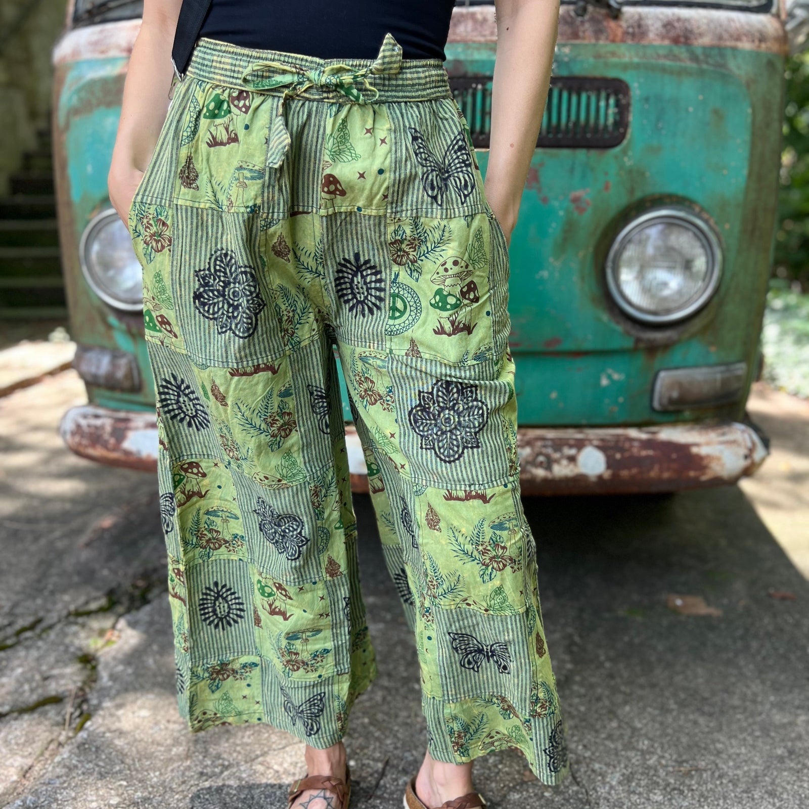 A woman wearing the Green Patch Cotton Palazzo Pants in front of a vintage Volkswagen bus.