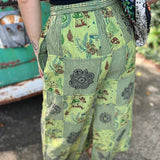 A woman wearing the Green Patch Cotton Palazzo Pants in front of a vintage Volkswagen bus.