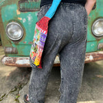 A woman wearing the Multi Patch Hippie Gypsy Cotton Trouser in front of a vintage Volkswagen bus.