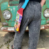 A woman wearing the Multi Patch Hippie Gypsy Cotton Trouser in front of a vintage Volkswagen bus.