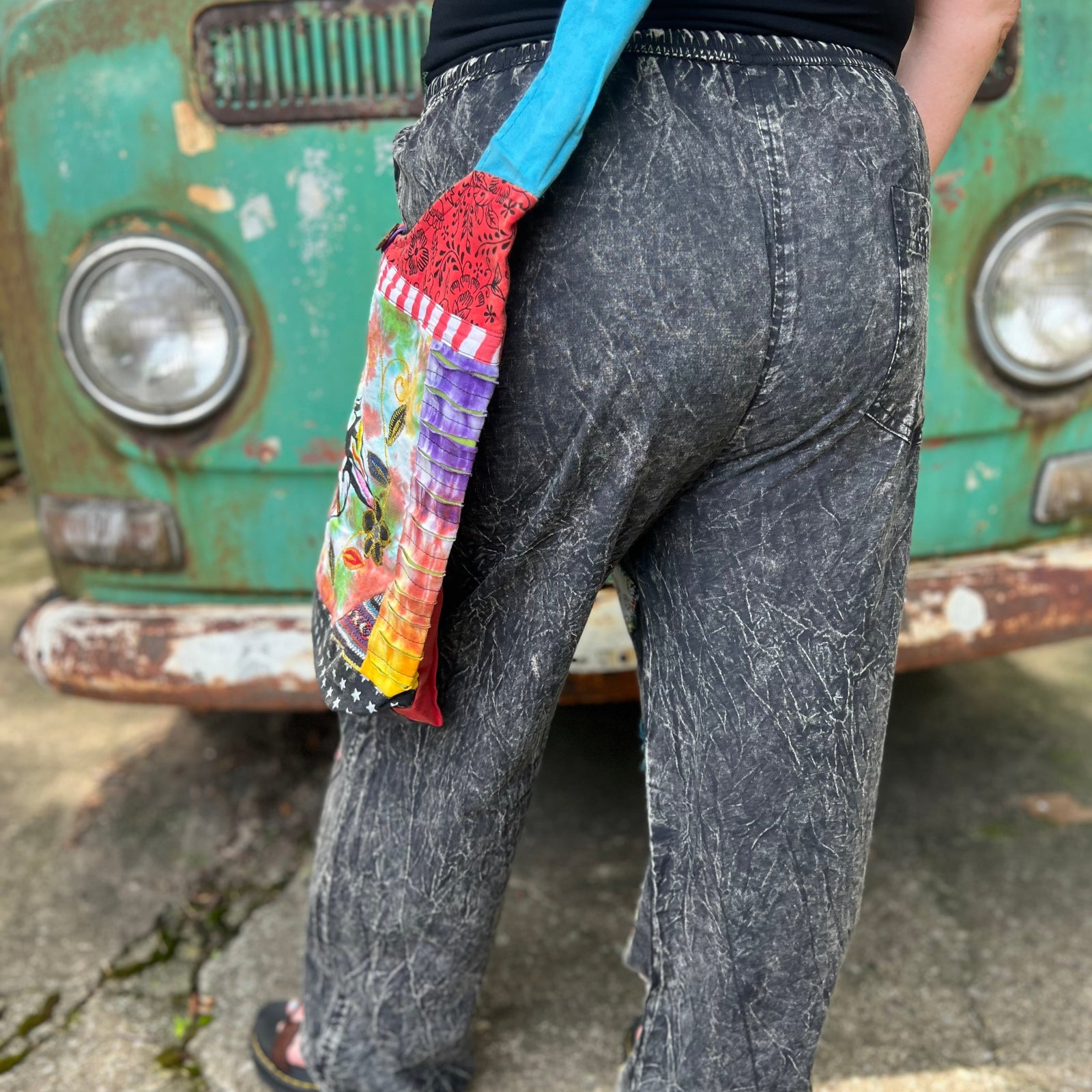 A woman wearing the Multi Patch Hippie Gypsy Cotton Trouser in front of a vintage Volkswagen bus.