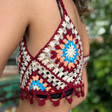 Someone wearing the Handmade Bohemian Crochet Design Cropped Camisole in front of an old teal Volkswagen bus.