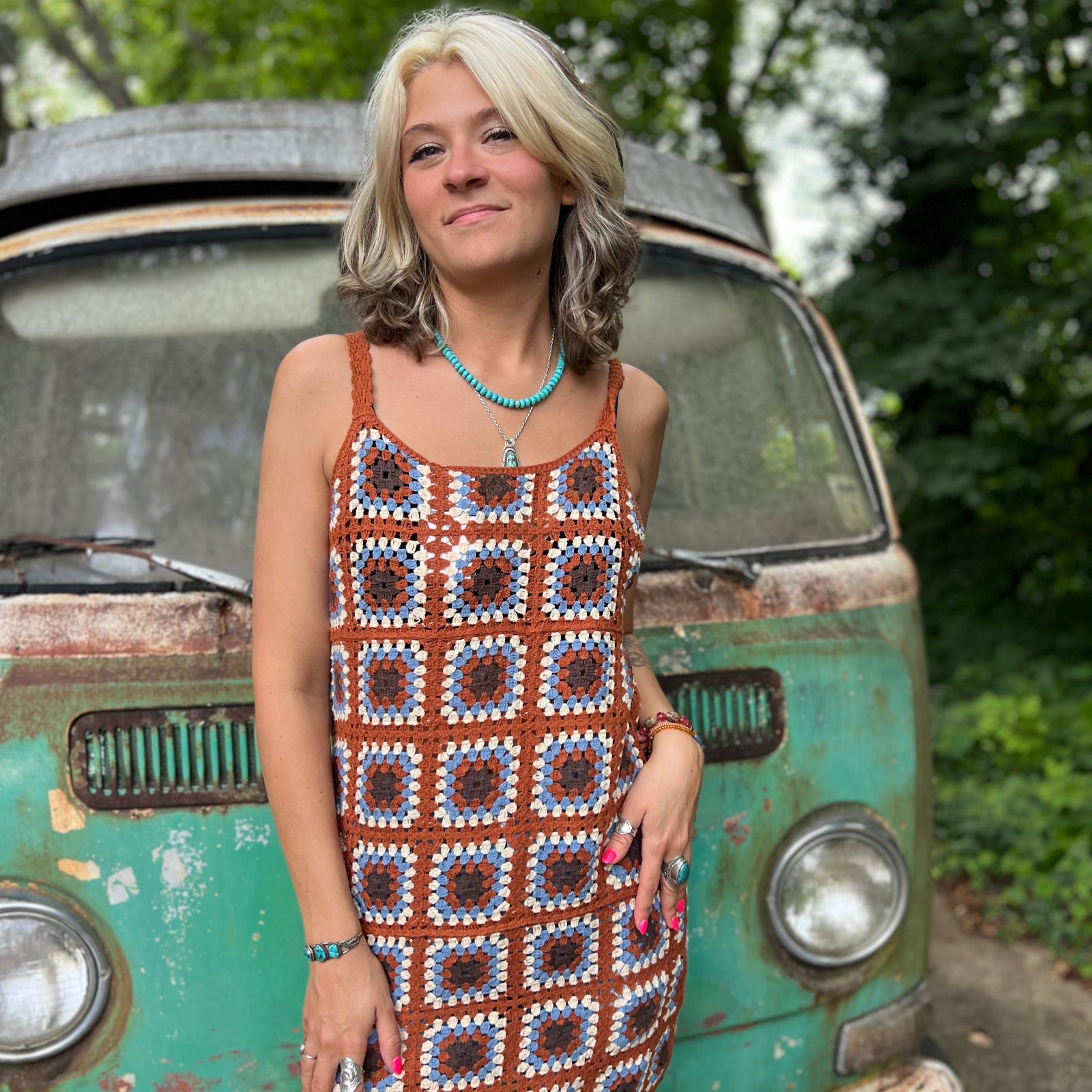 Someone wearing the coffee Sleeveless Knit Tank Dress in front of an old teal Volkswagen bus.