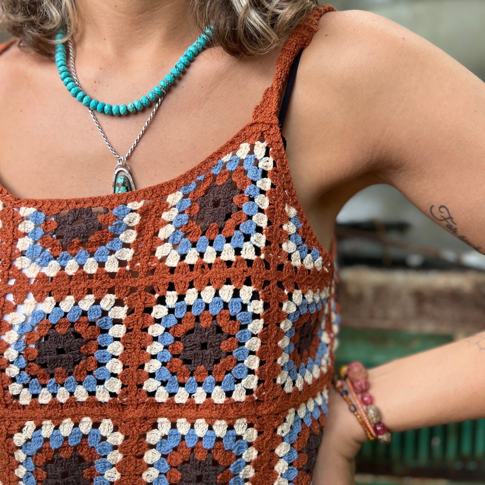 Someone wearing the coffee Sleeveless Knit Tank Dress in front of an old teal Volkswagen bus.